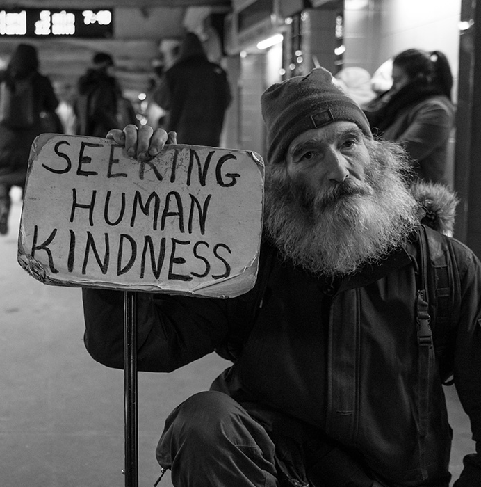 Homeless Man Holding Sign Asking for Kindness